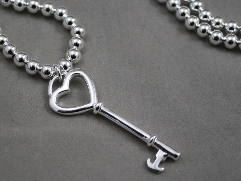 Silver beads with key
