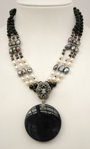Necklace of three strands of onyx, fresh water pearls and sterling silver beads with marcasite bars, and a drop of marcasite and large onyx disk